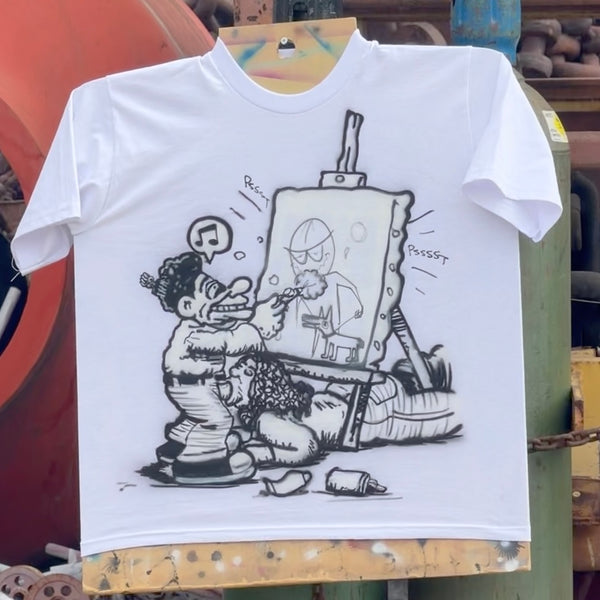 White short-sleeve tee featuring black cartoon artwork of an artist painting at an easel.